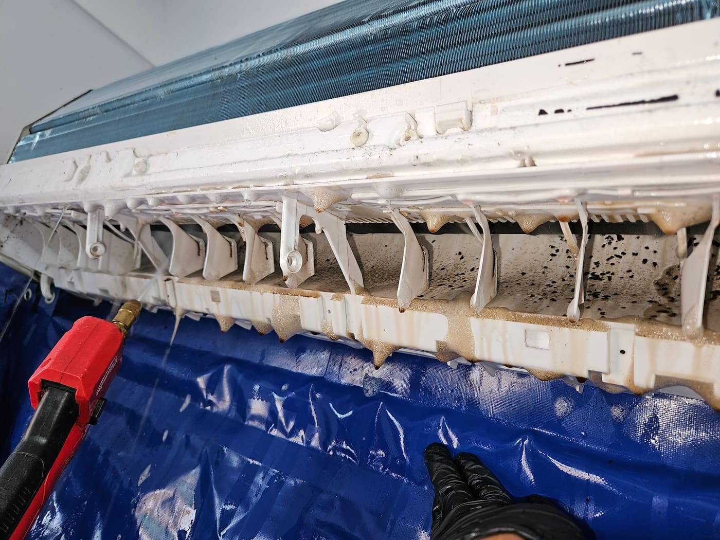AKO Air technician deep-cleaning a split system air conditioner